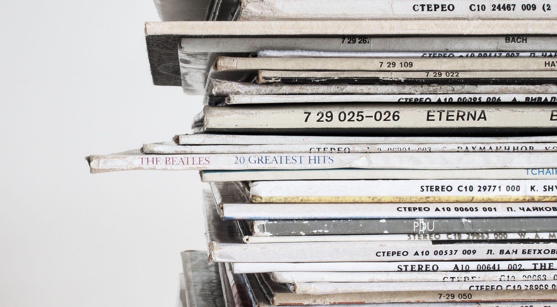 Stack of vintage vinyl record albums piled together.